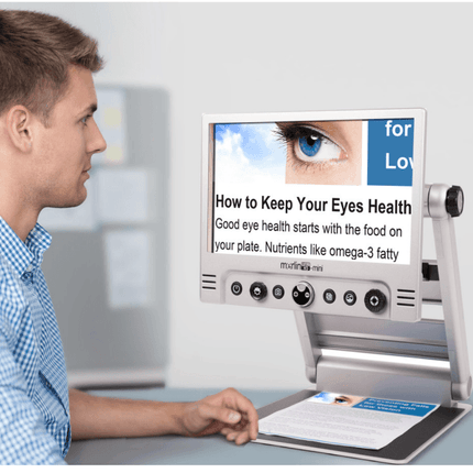 User reading health tips on the Merlin Mini portable video magnifier with clear display.