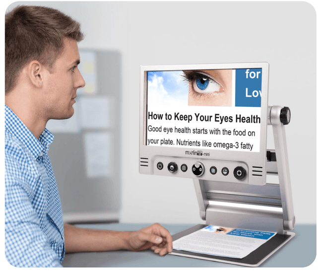 User reading health tips on the Merlin Mini portable video magnifier with clear display.