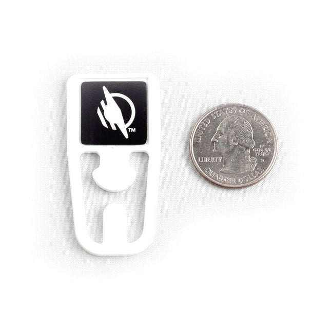 On-metal WayClip Plastic Clip with NFC Tag next to a quarter for size comparison.