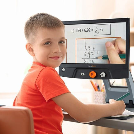 Child using a Reveal 16 full HD digital video magnifier for learning at home.