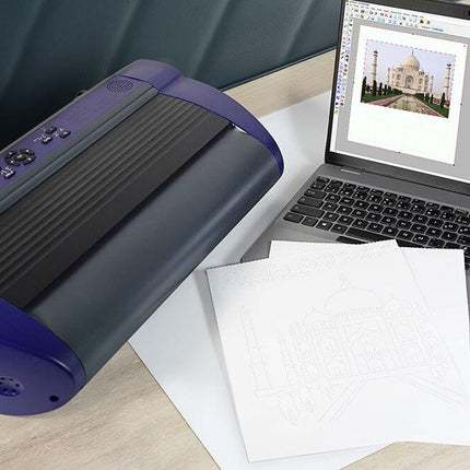 Romeo 60 braille embosser for tactile documents beside a laptop and tactile printouts.