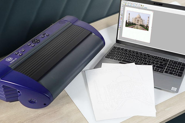 Romeo 60 braille embosser for tactile documents beside a laptop and tactile printouts.