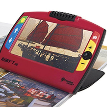 RUBY 7 HD portable video magnifier displaying an image of a ship on a magazine.
