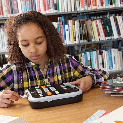Young girl using the Victor Reader Stratus12 M Daisy and MP3 reader at a library table.