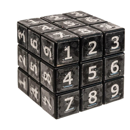 braille sudoku cube featuring bold numbers 1-9 on connected black cubes for tactile puzzle solving.