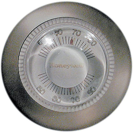 Thermostat magnifier for visually impaired users, enhancing visibility of temperature markings on Honeywell thermostat.