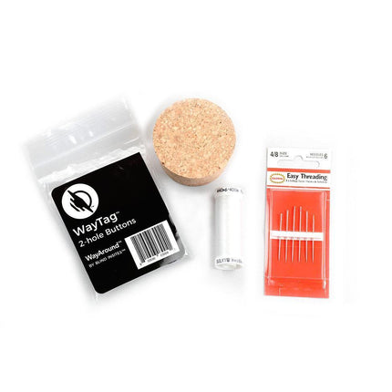 WayAround laundry tagging kit including WayTag 2-hole buttons, cork, and self-threading needles.