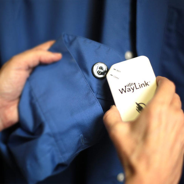 Person attaching the WayTag 2-hole buttons to a shirt using the WayLink app, showcasing wireless 2-hole buttons.