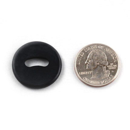 WayTag oval hole buttons next to a quarter for size comparison, showcasing a sleek black design.