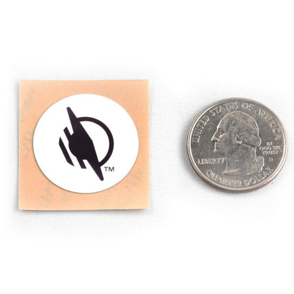 Wireless WayTag stickers displayed next to a quarter for size comparison.