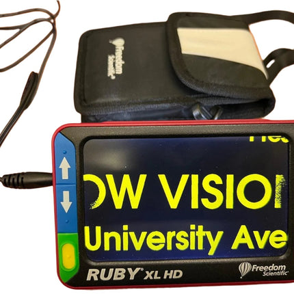 Used Ruby XL HD video magnifier displaying text with built-in LED lighting and portable carrying case