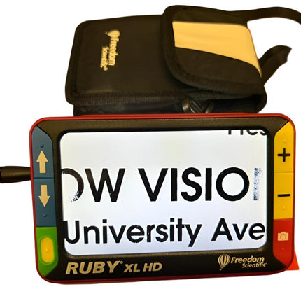 Used Ruby XL HD video magnifier on display with carrying case, featuring a 5-inch screen and built-in LED lighting.